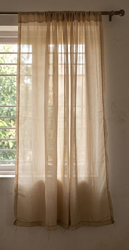 The thin, see-through curtain that arrived, with the window visible through it